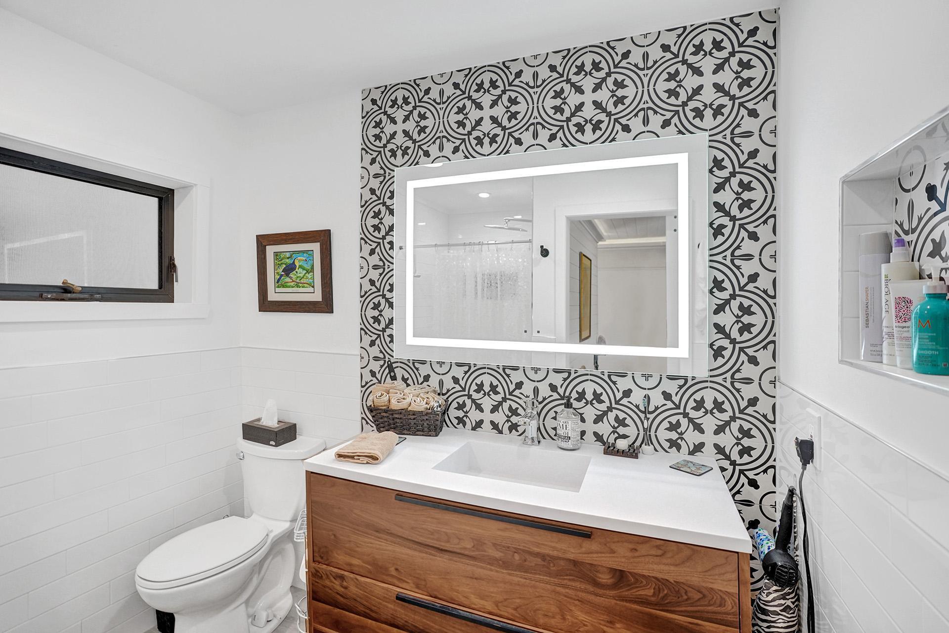 5612 Harding Street Hollywood, FL 33021 - Photo 31 of 59 a bathroom with a sink a toilet and mirror