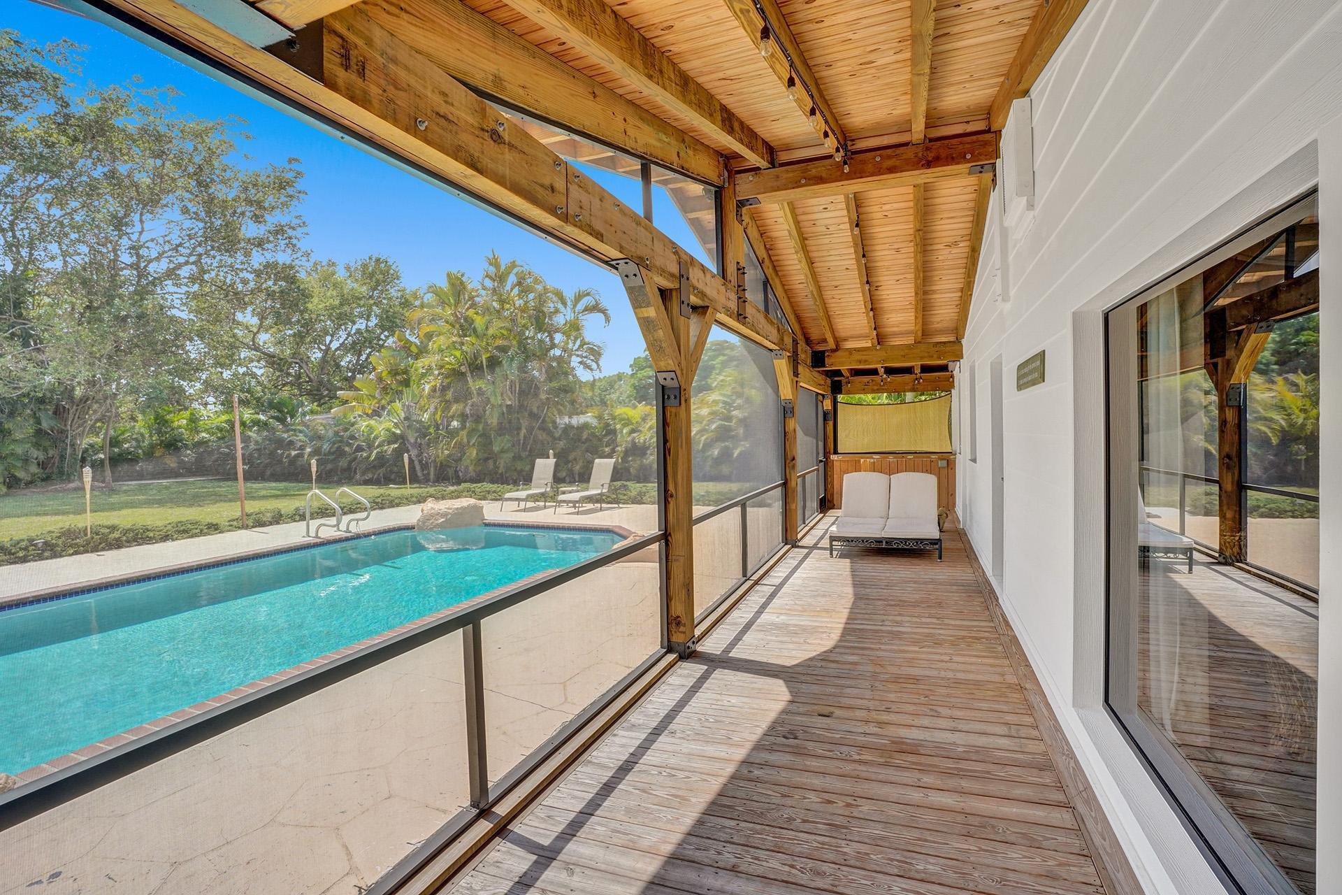 5612 Harding Street Hollywood, FL 33021 - Photo 36 of 59 a view of a balcony with wooden floor and outdoor space