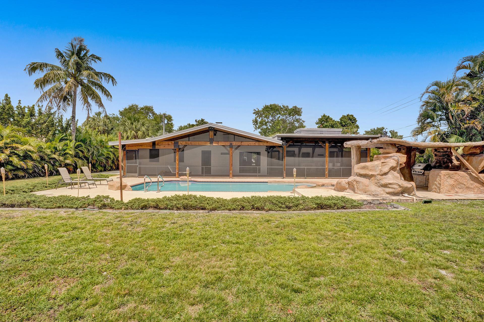 5612 Harding Street Hollywood, FL 33021 - Photo 44 of 59 a house with swimming pool in front of it
