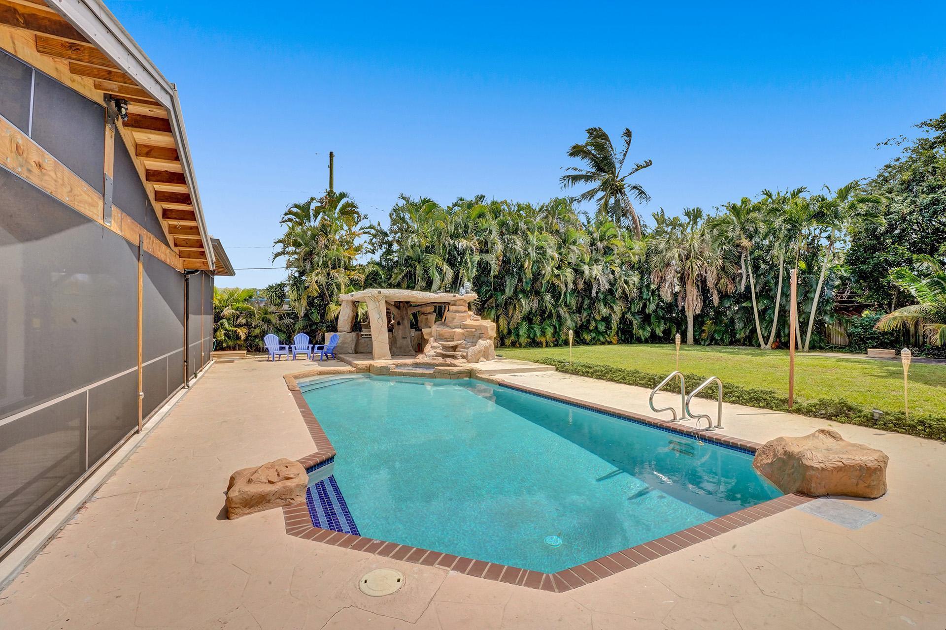 5612 Harding Street Hollywood, FL 33021 - Photo 45 of 59 a view of a swimming pool with a yard