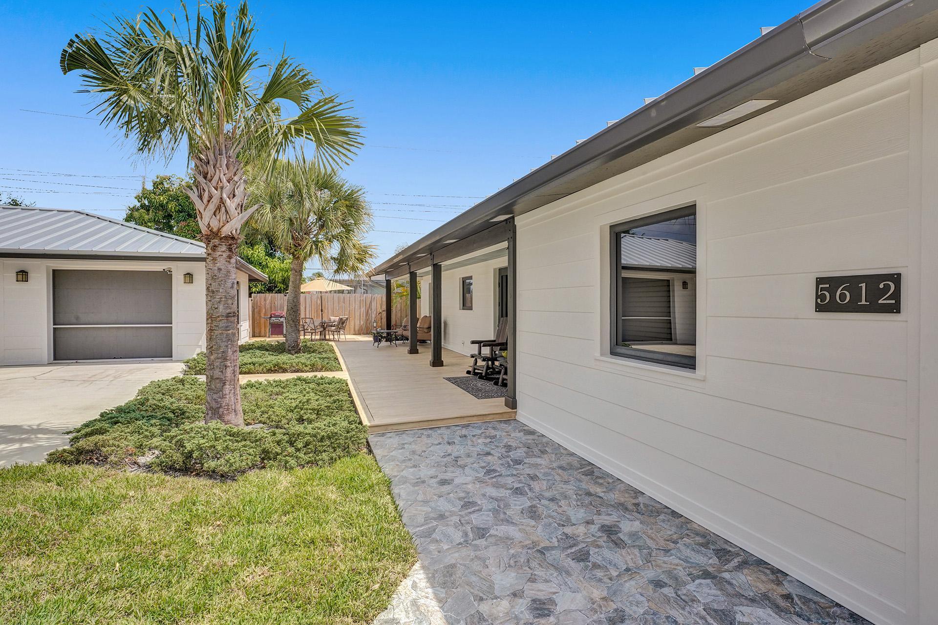 5612 Harding Street Hollywood, FL 33021 - Photo 49 of 59 a front view of a house with a yard and potted plants