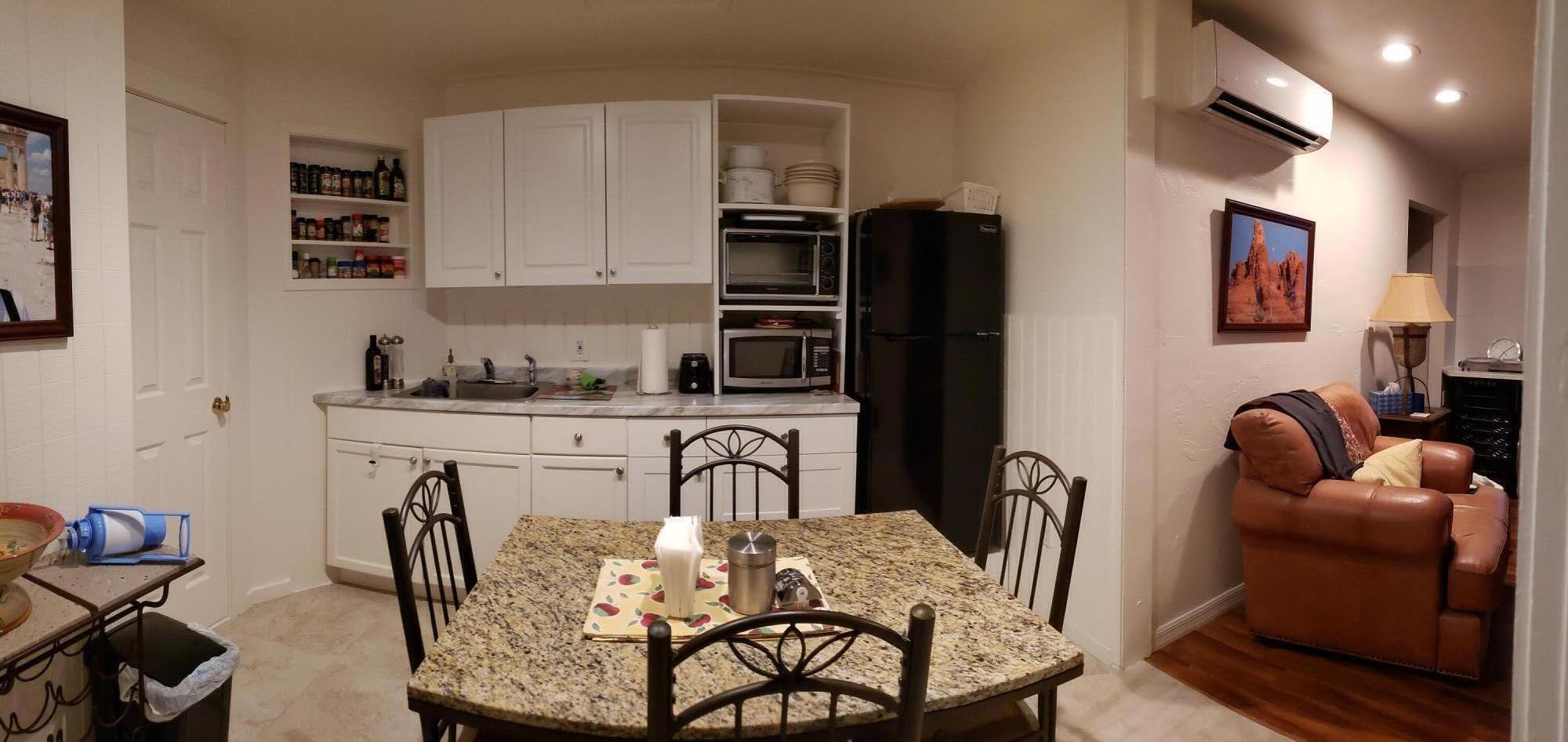5612 Harding Street Hollywood, FL 33021 - Photo 57 of 59 a kitchen with stainless steel appliances granite countertop a table and chairs in it