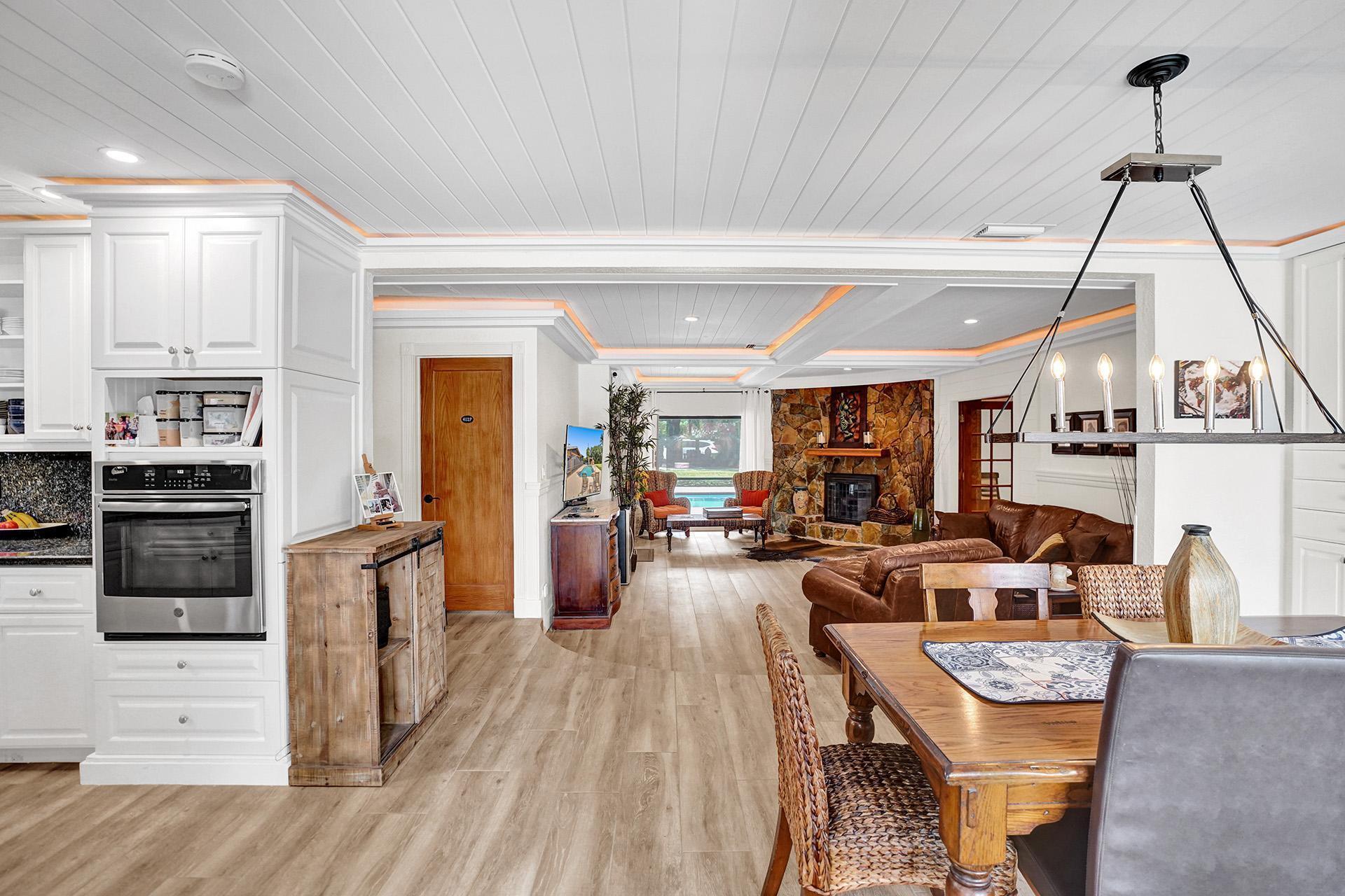 5612 Harding Street Hollywood, FL 33021 - Photo 8 of 59 a living room with furniture a flat screen tv and kitchen view