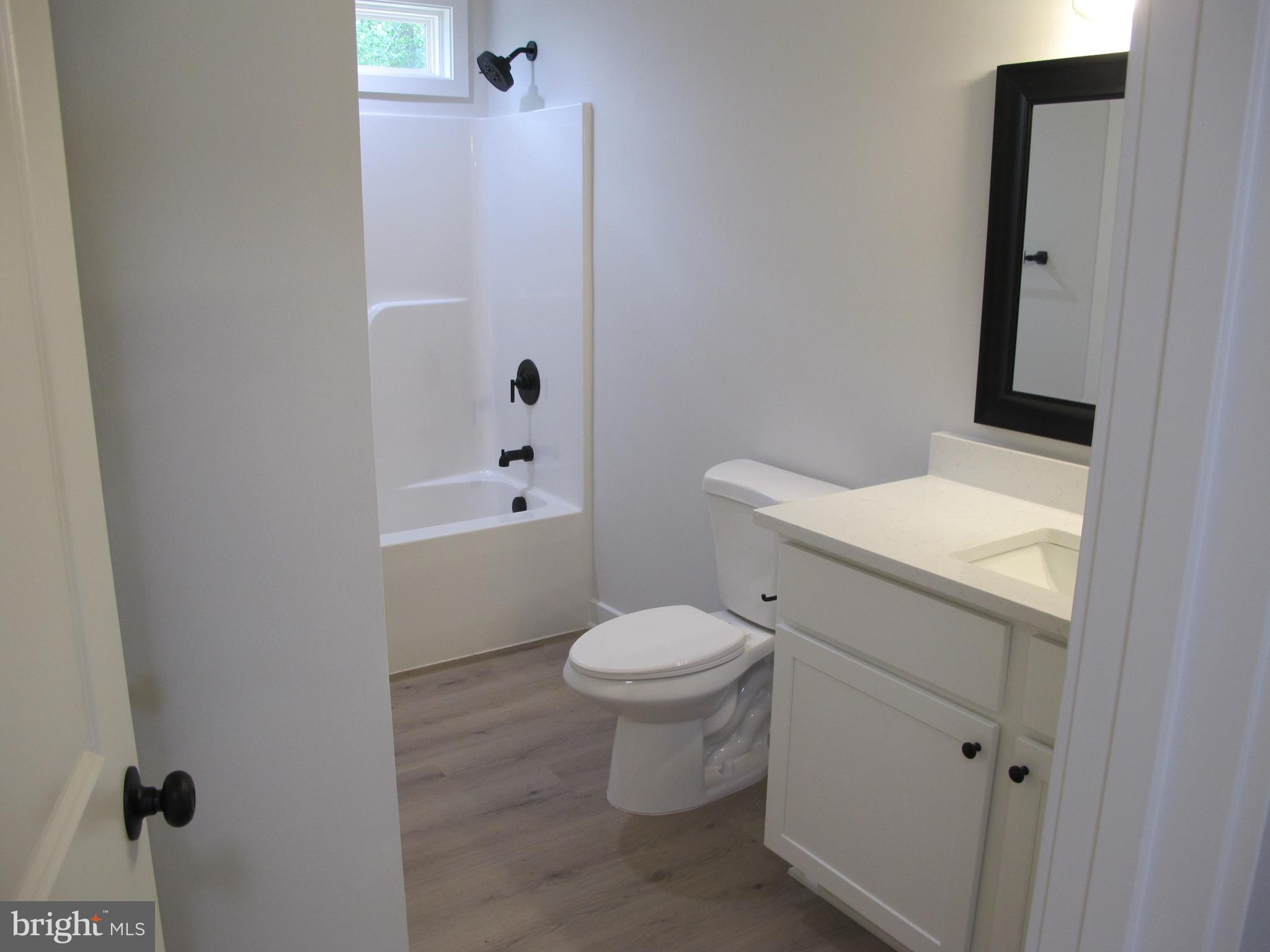 145 9th Street Colonial Beach, VA 22443 - Photo 27 of 51 a bathroom with a sink a toilet and shower