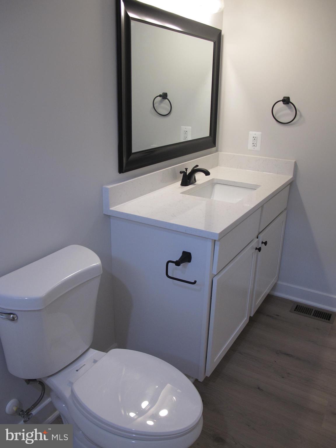 145 9th Street Colonial Beach, VA 22443 - Photo 31 of 51 a bathroom with a toilet sink and mirror