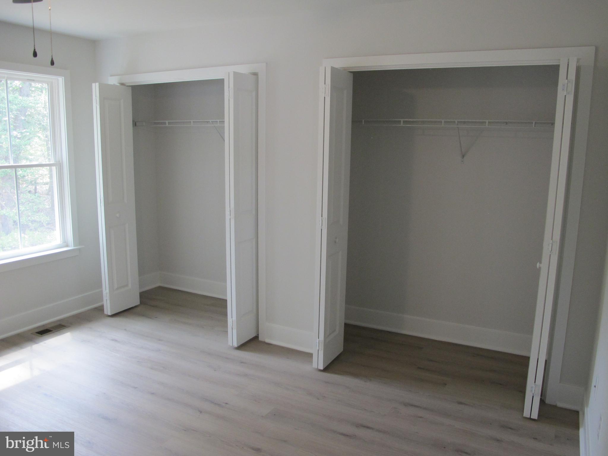 145 9th Street Colonial Beach, VA 22443 - Photo 39 of 51 an empty room with wooden floor and windows