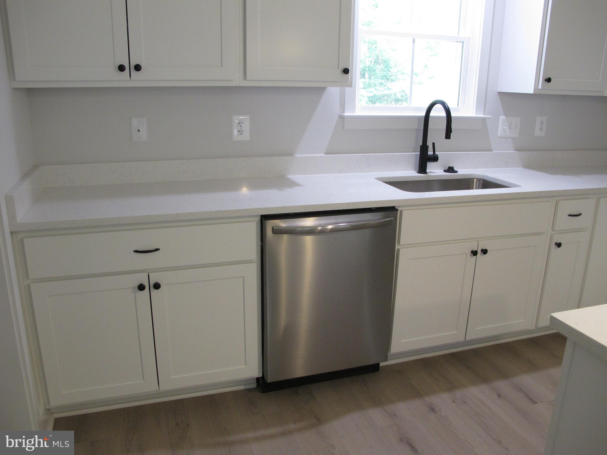 145 9th Street Colonial Beach, VA 22443 - Photo 49 of 51 a kitchen with a sink and cabinets