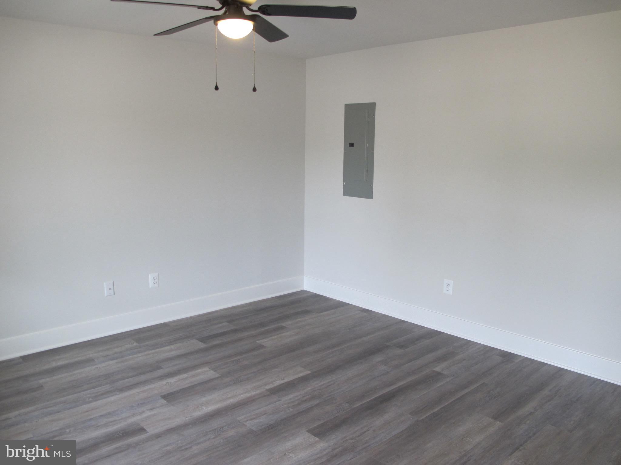 145 9th Street Colonial Beach, VA 22443 - Photo 5 of 51 a view of an empty room with wooden floor