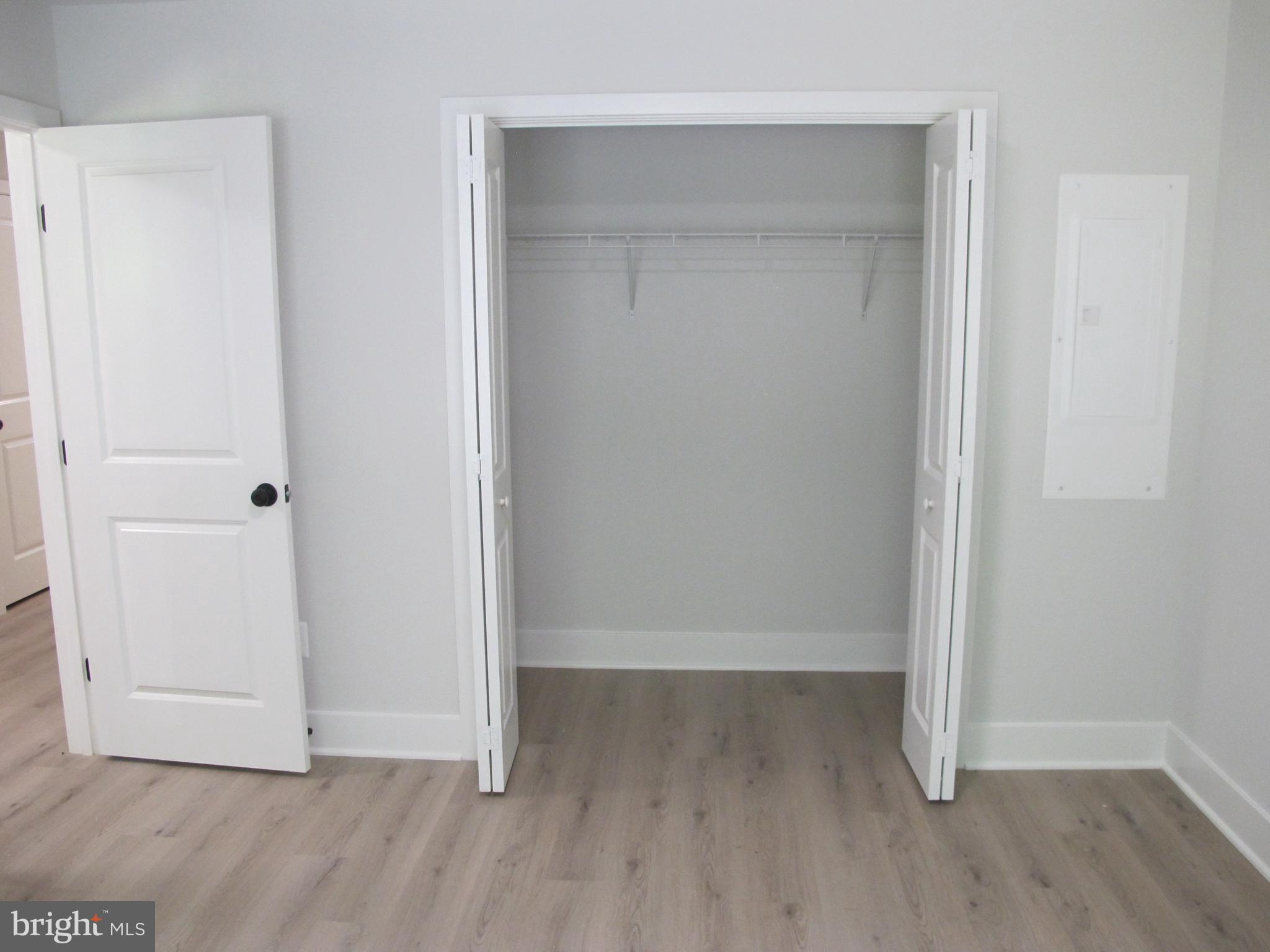 145 9th Street Colonial Beach, VA 22443 - Photo 10 of 51 an empty room with wooden floor and closet