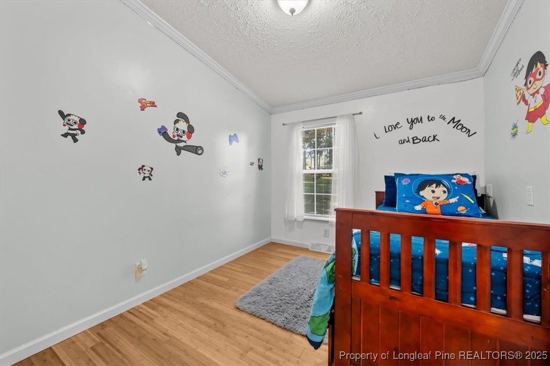 11891 Aberdeen Road Aberdeen, NC 28315 - Photo 23 of 35 a view of a baby room with a baby crib