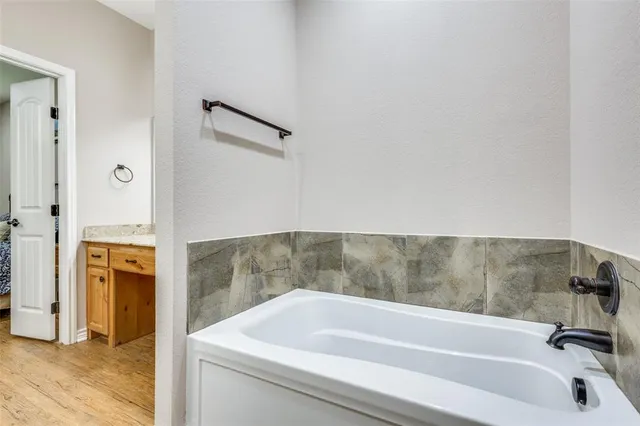 a bathroom with a tub and a sink