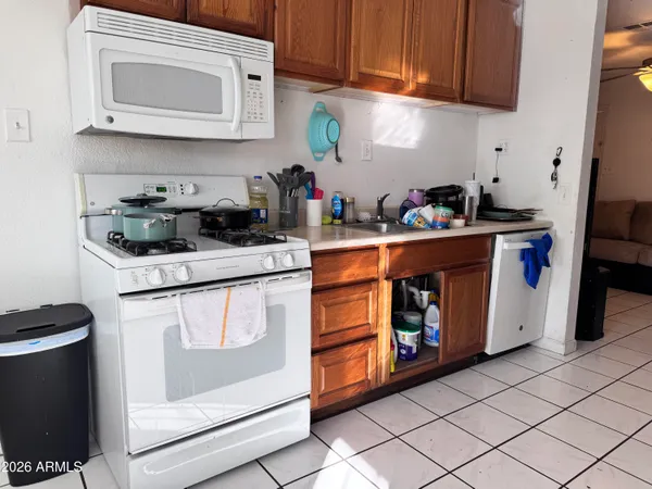 a kitchen with stainless steel appliances granite countertop a stove a microwave and a refrigerator