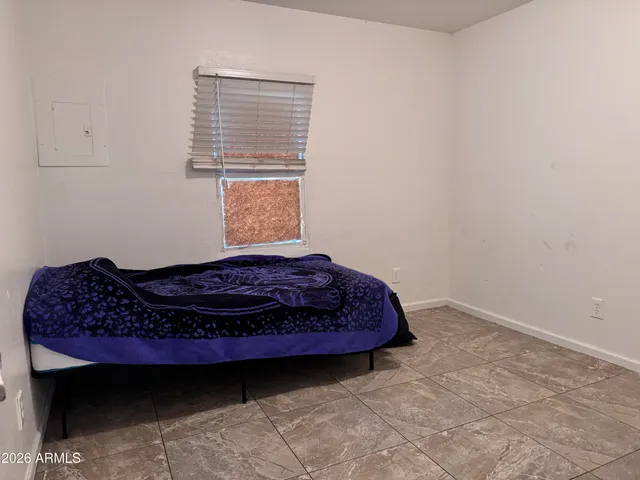 a bed sitting in a bedroom next to a window