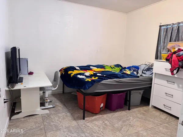 a bedroom with a bed and a desk