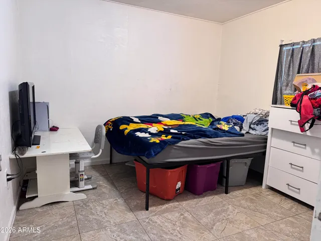 a bedroom with a bed and a desk