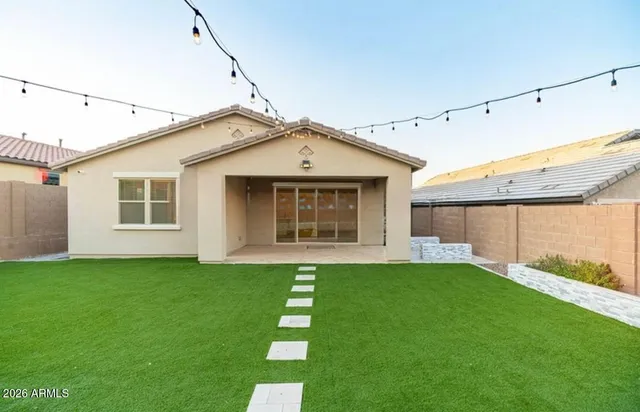 a backyard of a house with table and chairs