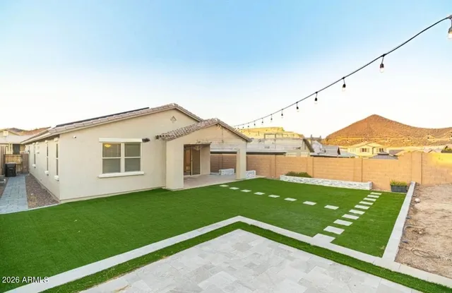 a view of a house with a yard and a garden