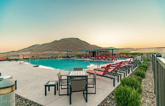 a view of swimming pool with outdoor seating