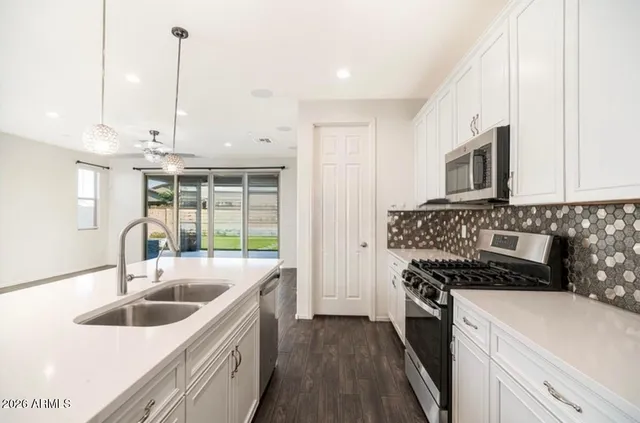 a kitchen that has a sink and a stove