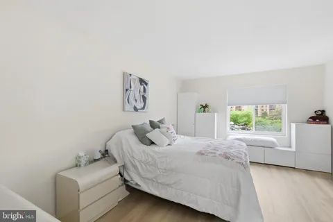 a bedroom with a bed and a couch