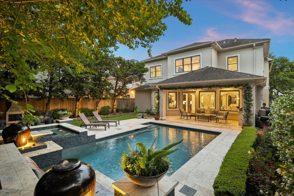 a view of a house with swimming pool and sitting area