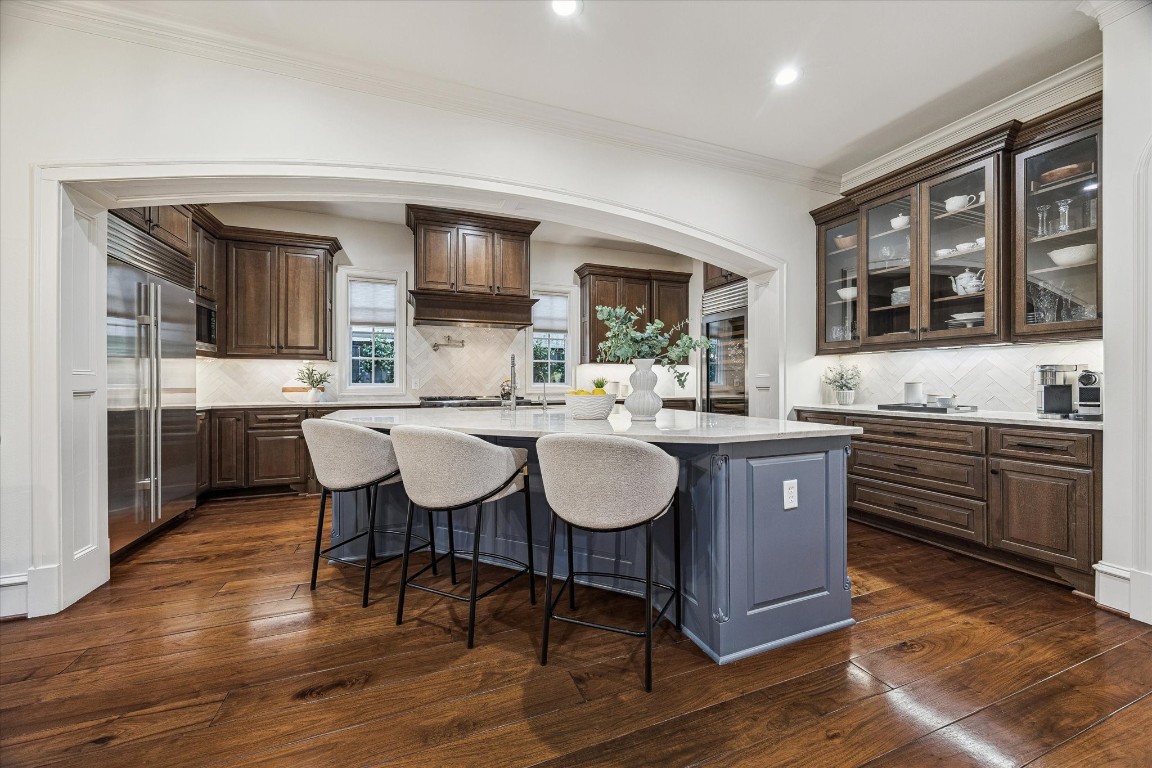 3810 Drake Street Houston, TX 77005 - Photo 11 of 48 a kitchen with stainless steel appliances granite countertop a kitchen island a stove a table and chairs