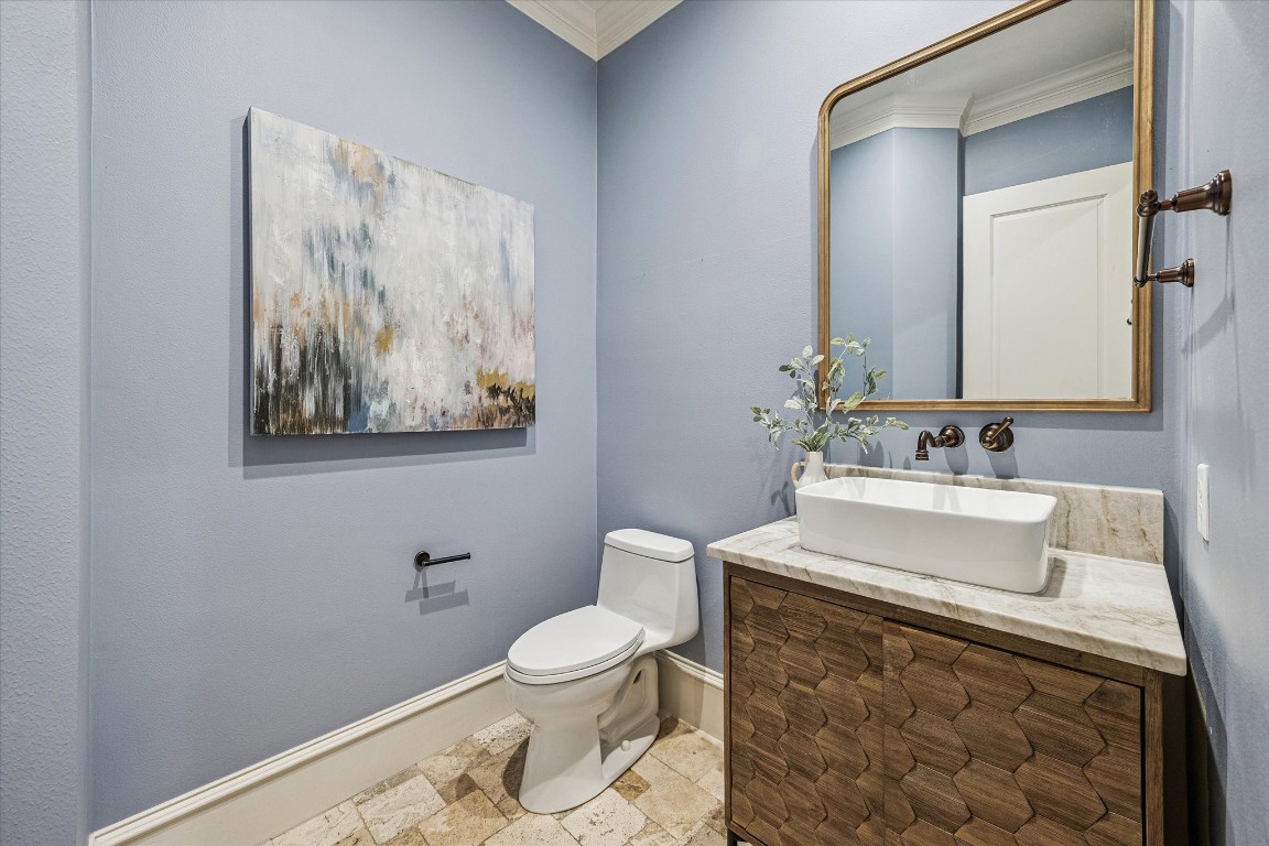 3810 Drake Street Houston, TX 77005 - Photo 18 of 48 POWDER. Like every room in this home, the powder room has generous dimensions and is privately located away from the main living and kitchen areas. Featuring custom vanity, travertine floor tiles and powder blue paint.