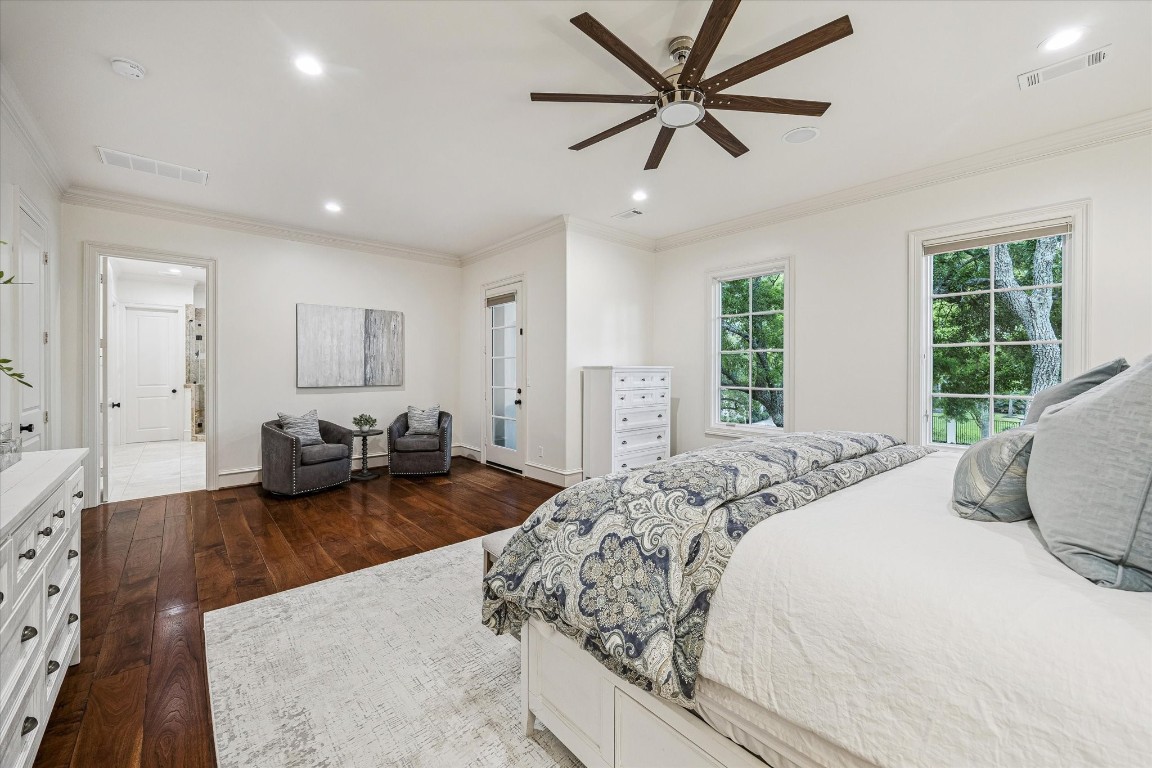 3810 Drake Street Houston, TX 77005 - Photo 21 of 48 PRIMARY SUITE. Pretty tree top views. Note the walnut flooring, layered crown molding and stepped 6 inch baseboards continue throughout the second floor.