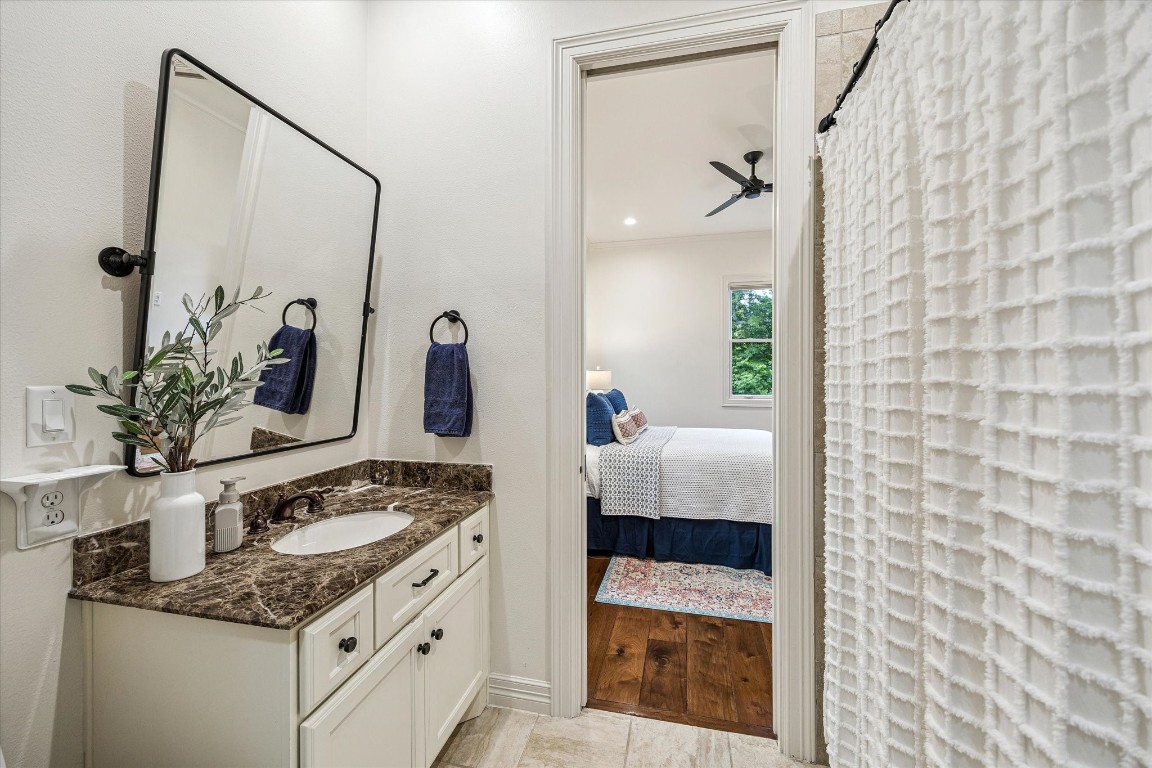 3810 Drake Street Houston, TX 77005 - Photo 26 of 48 a en suite bathroom with a granite countertop sink and a mirror