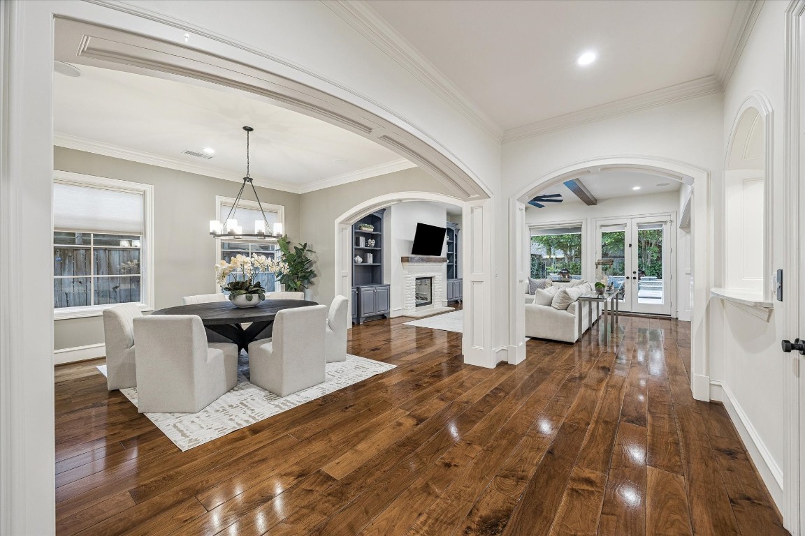 3810 Drake Street Houston, TX 77005 - Photo 3 of 48 a view of a dining room with furniture a chandelier and wooden floor