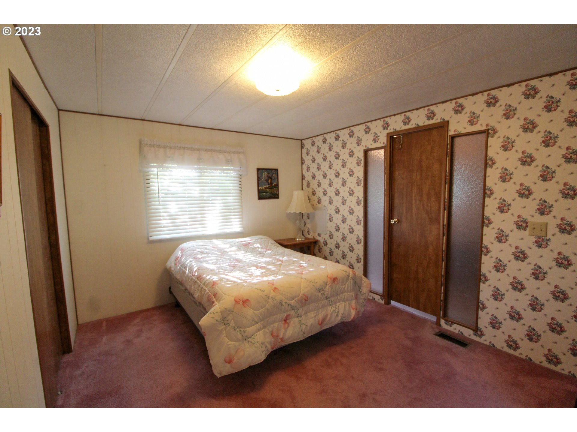 1400 Candlelight Drive, Unit 160 Eugene, OR 97402 - Photo 12 of 31 a bedroom with a bed and a window