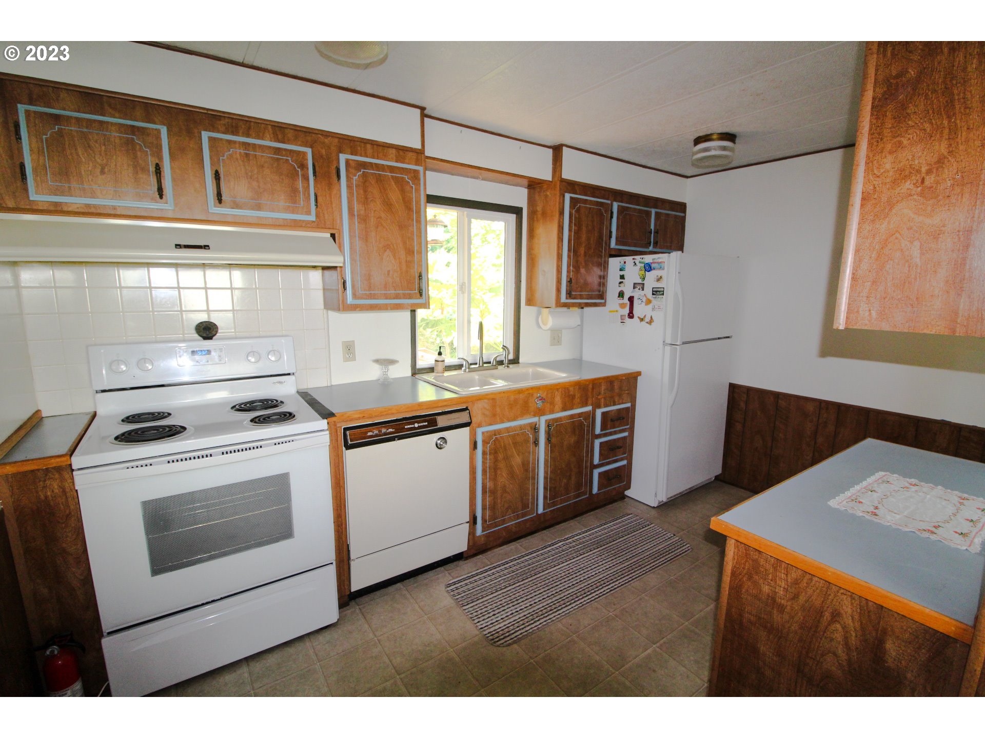 1400 Candlelight Drive, Unit 160 Eugene, OR 97402 - Photo 5 of 31 a kitchen with stainless steel appliances a stove a sink and a microwave