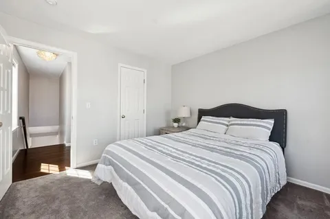 a bedroom with a bed and a mirror