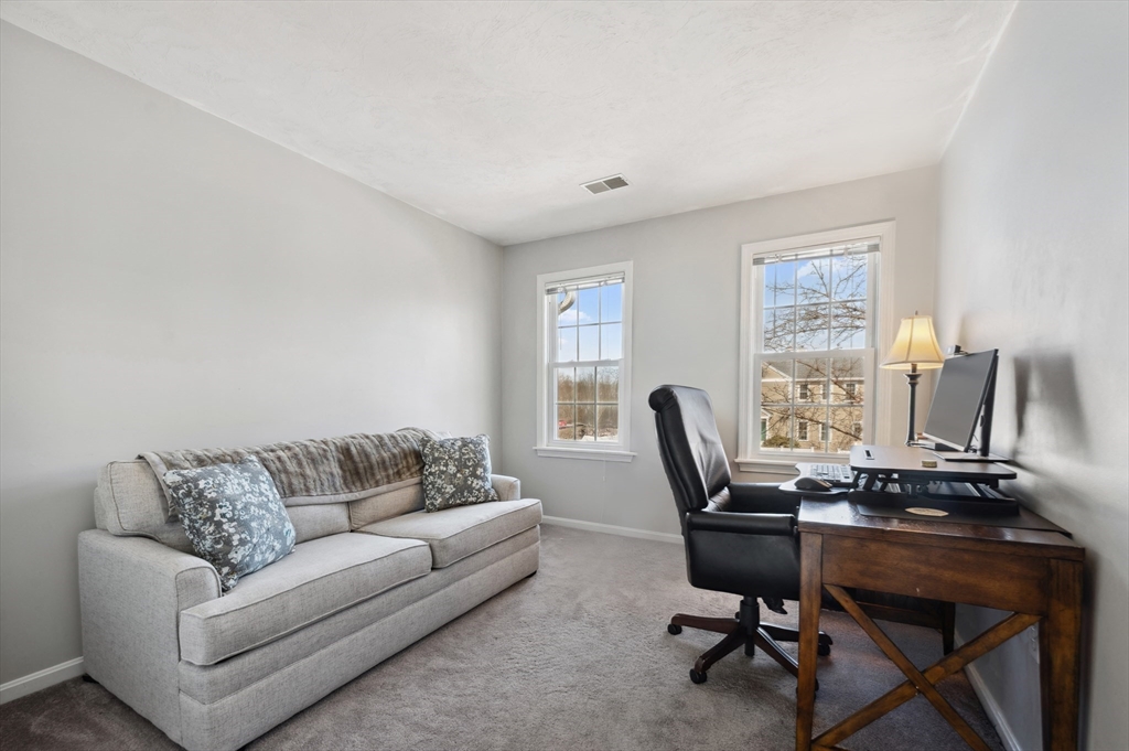 354 Tilden Commons Lane, Unit 354 Braintree, MA 02184 - Photo 14 of 35 a livingroom with workspace couch and a window