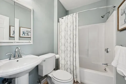 a bathroom with a sink toilet and shower