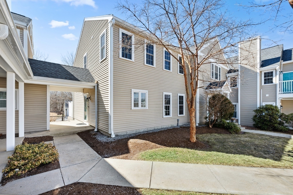 354 Tilden Commons Lane, Unit 354 Braintree, MA 02184 - Photo 20 of 35 a front view of a house with a yard