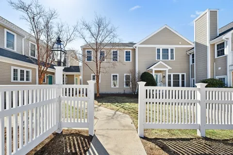 a front view of a house with a fence