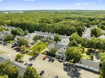 an aerial view of residential houses with outdoor space