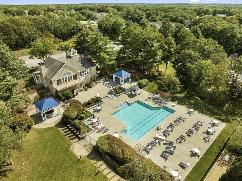 354 Tilden Commons Lane, Unit 354 Braintree, MA 02184 - Photo 24 of 35 a view of a table and chairs in the patio
