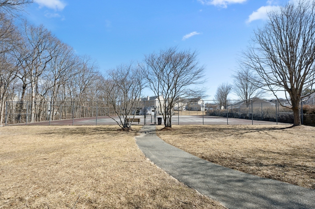 354 Tilden Commons Lane, Unit 354 Braintree, MA 02184 - Photo 31 of 35 a view of a yard with snow on the road