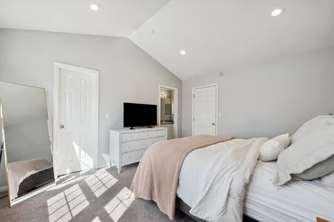 a bedroom with a bed and a flat screen tv