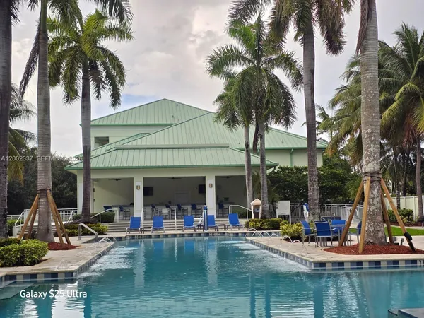 a view of a swimming pool with chairs