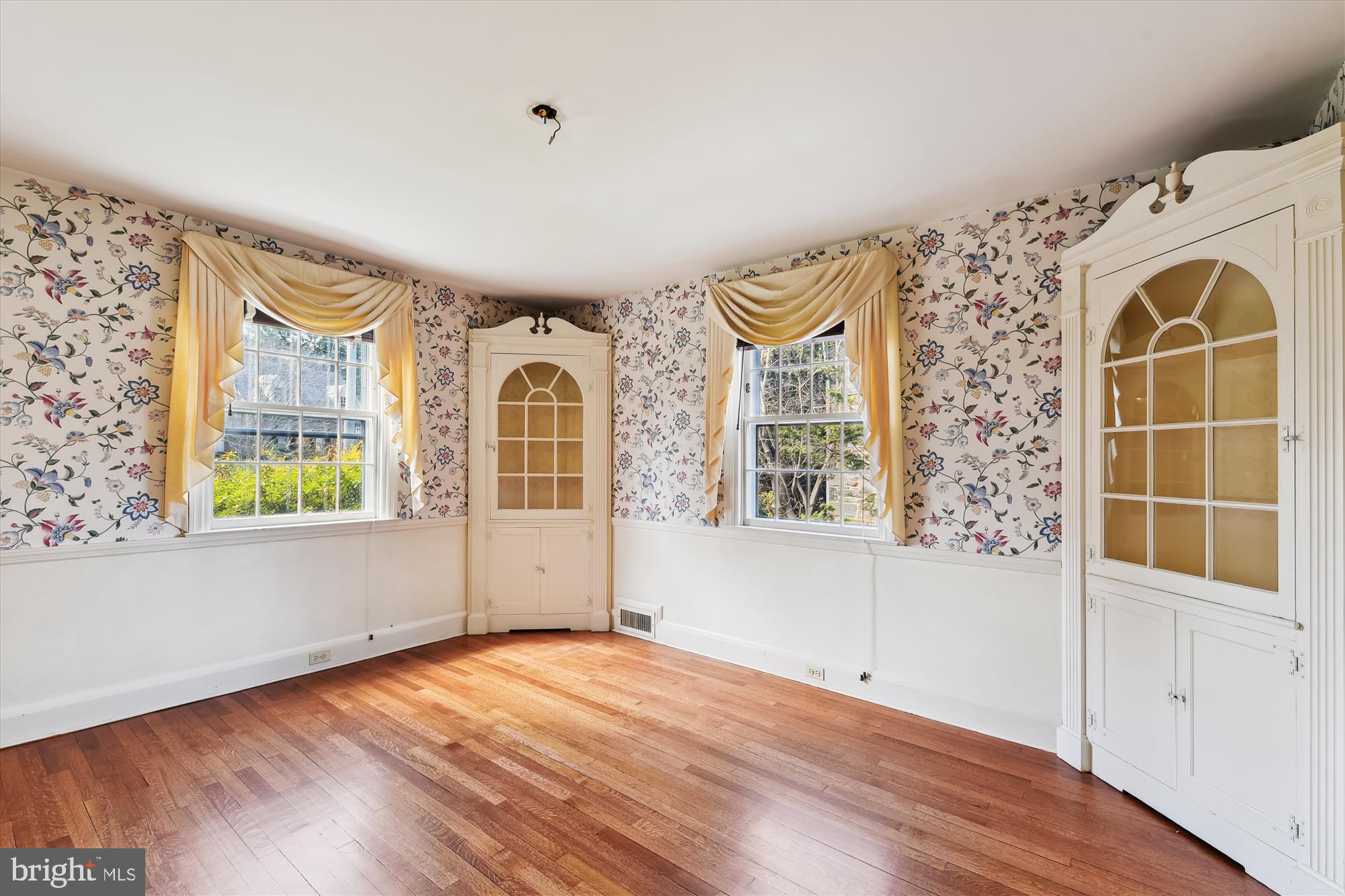 5433 Springlake Way Baltimore, MD 21212 - Photo 9 of 58 a view of an empty room with a window and wooden floor