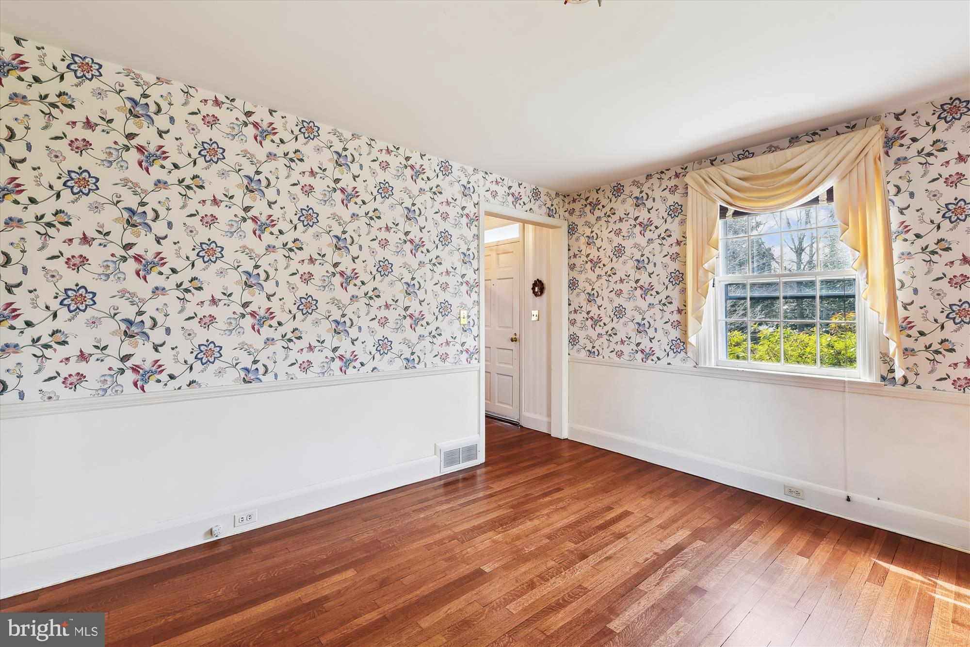5433 Springlake Way Baltimore, MD 21212 - Photo 12 of 58 an empty room with wooden floor and windows