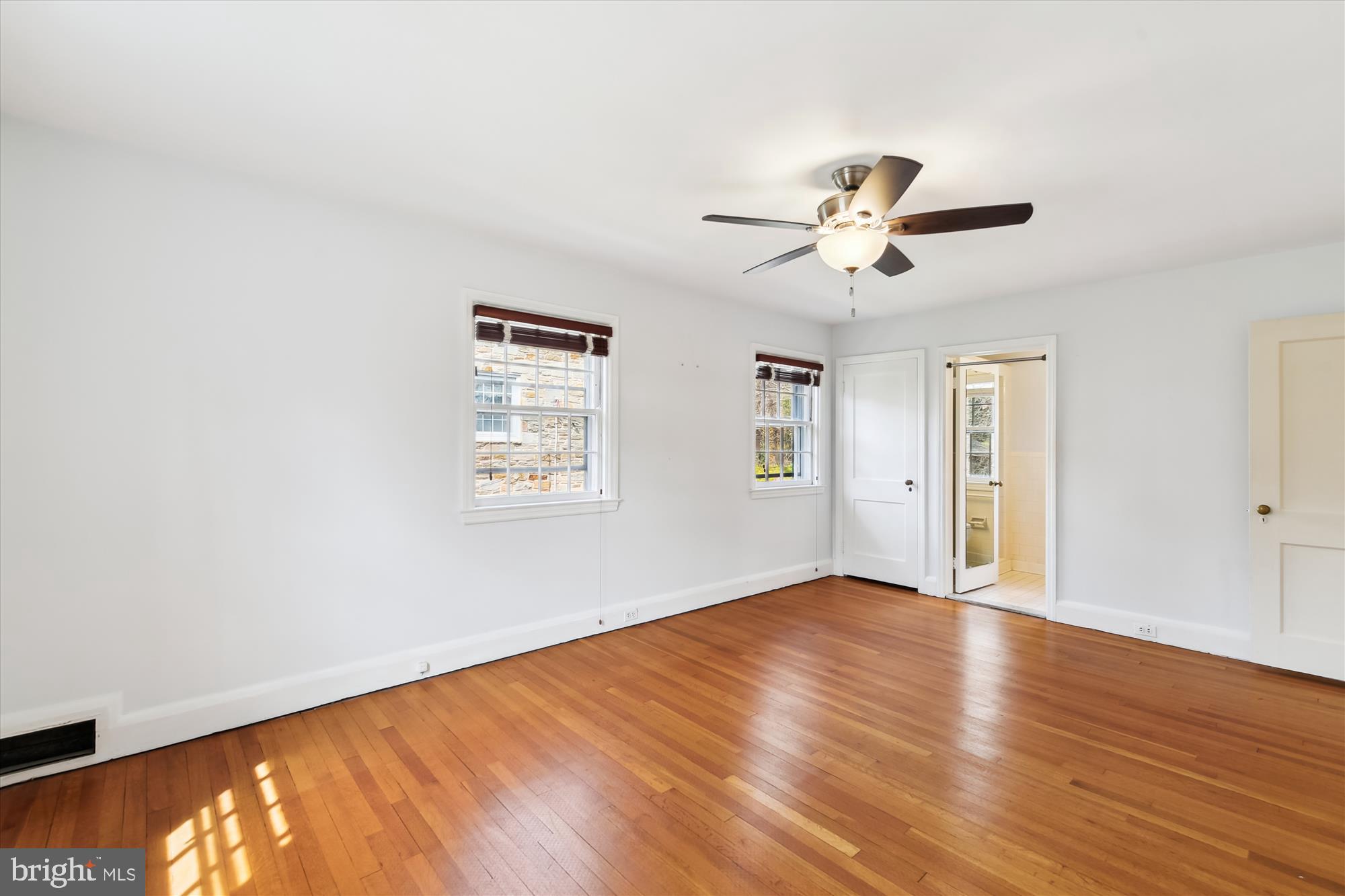 5433 Springlake Way Baltimore, MD 21212 - Photo 23 of 58 wooden floor in an empty room with a window