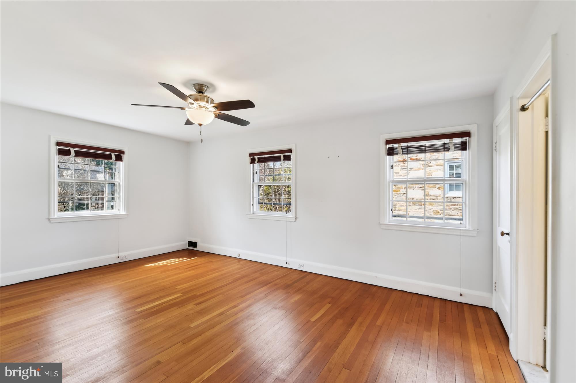 5433 Springlake Way Baltimore, MD 21212 - Photo 26 of 58 a view of an empty room with wooden floor and a window