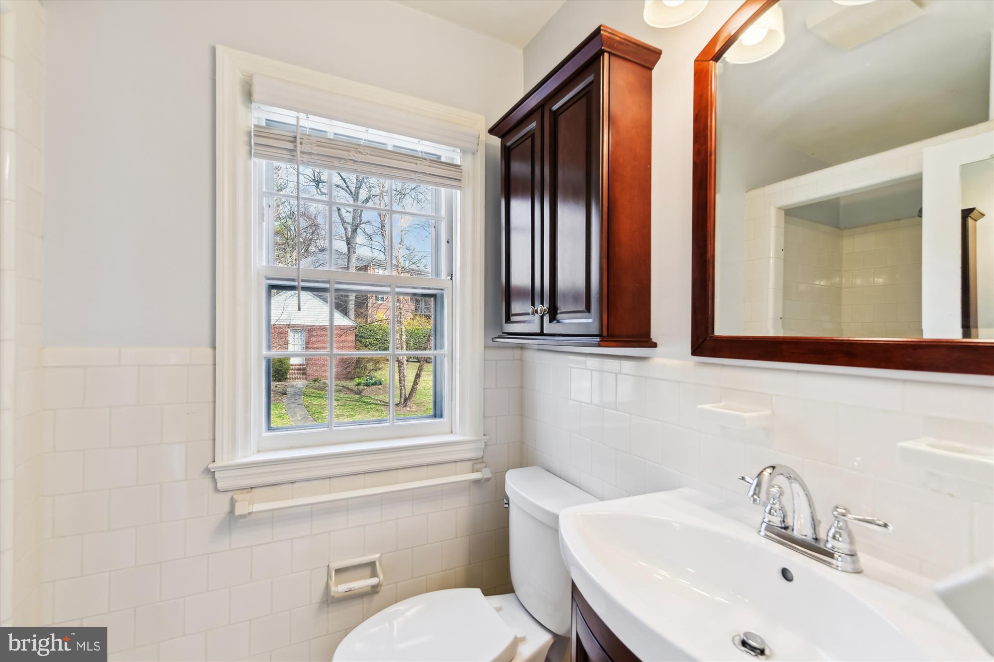 5433 Springlake Way Baltimore, MD 21212 - Photo 27 of 58 a bathroom with a sink and a mirror