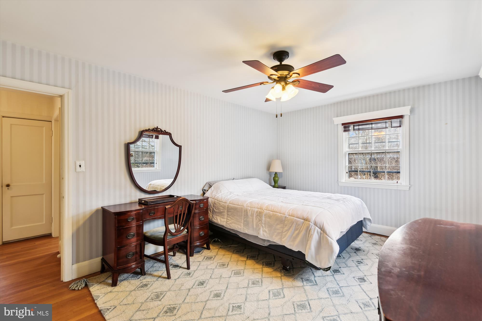 5433 Springlake Way Baltimore, MD 21212 - Photo 29 of 58 a bedroom with a bed a chandelier and a window