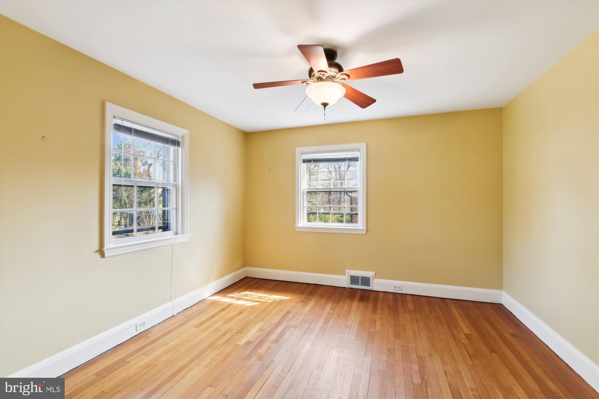 5433 Springlake Way Baltimore, MD 21212 - Photo 33 of 58 a view of an empty room with wooden floor and a window