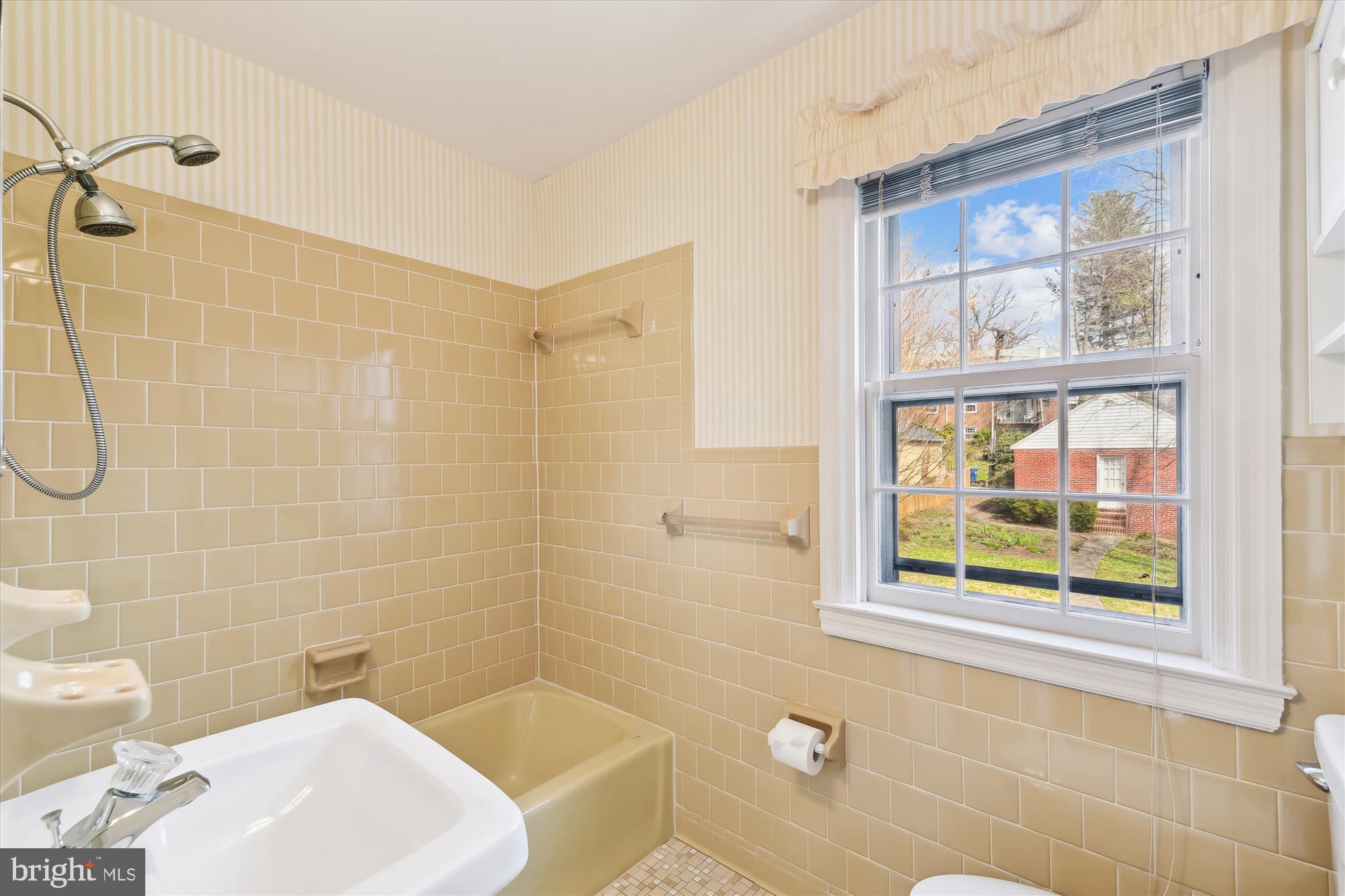5433 Springlake Way Baltimore, MD 21212 - Photo 37 of 58 a bathroom with a sink and a bathtub